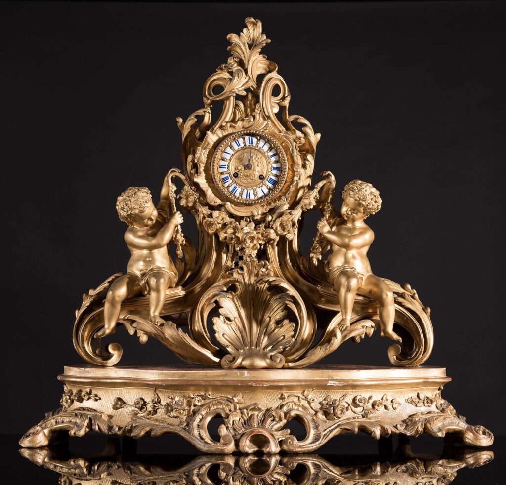 Important gilt bronze three-piece clock garniture comprising a clock and a pair of candelabra.