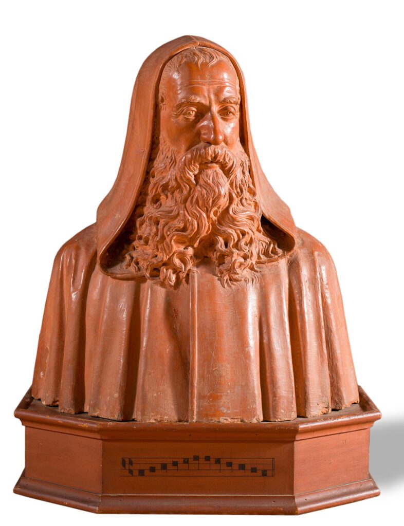 “Guido Monaco, conosciuto anche come Guido D'Arezzo”, busto in terracotta su base di legno.