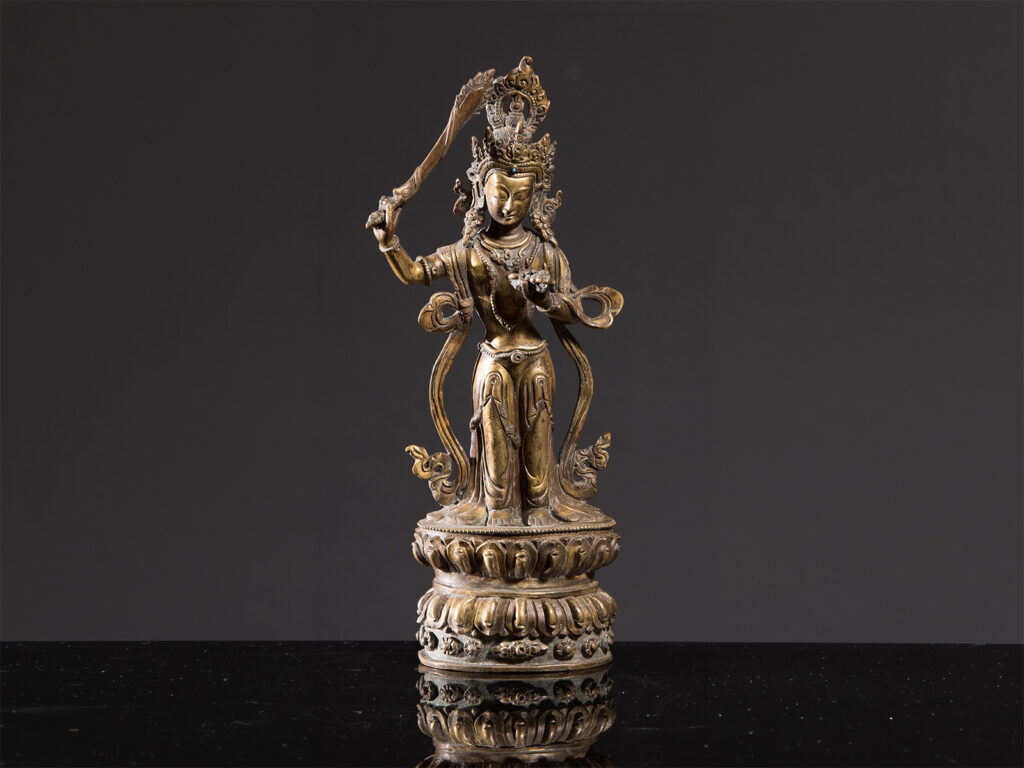 Figura tibetana di Tara in rame e bronzo con intarsi in turchese, su base a fiore di loto, inizio XIX secolo.